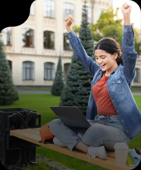 Student celebrating with laptop